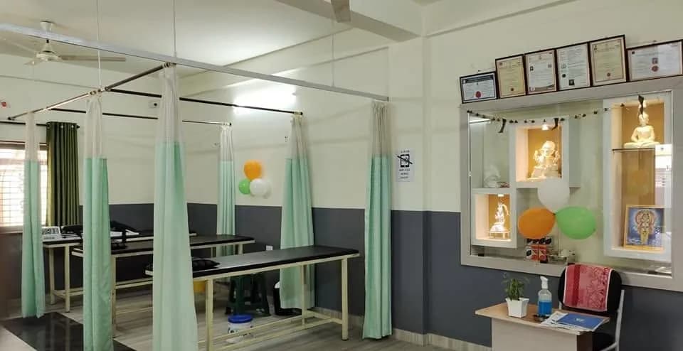 Curtained physiotherapy treatment bays inside the clinic