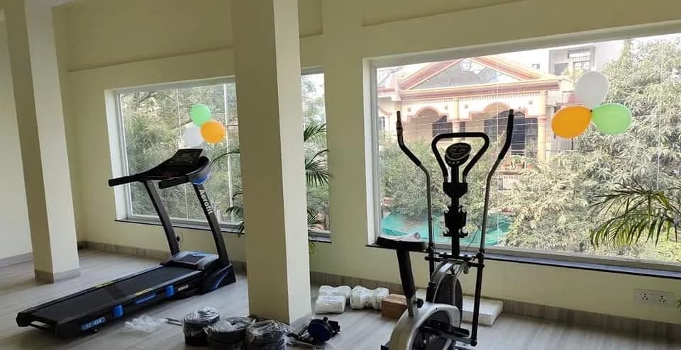 Fitness Hub with treadmill and cross-trainer overlooking the street
