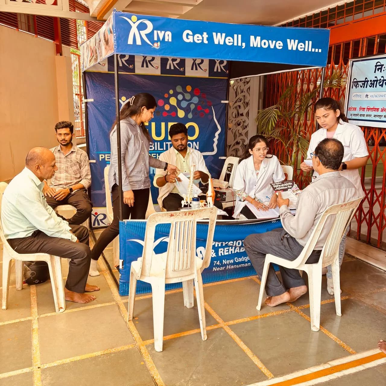 Riva Clinic neuro-rehabilitation camp stall with the team consulting patients