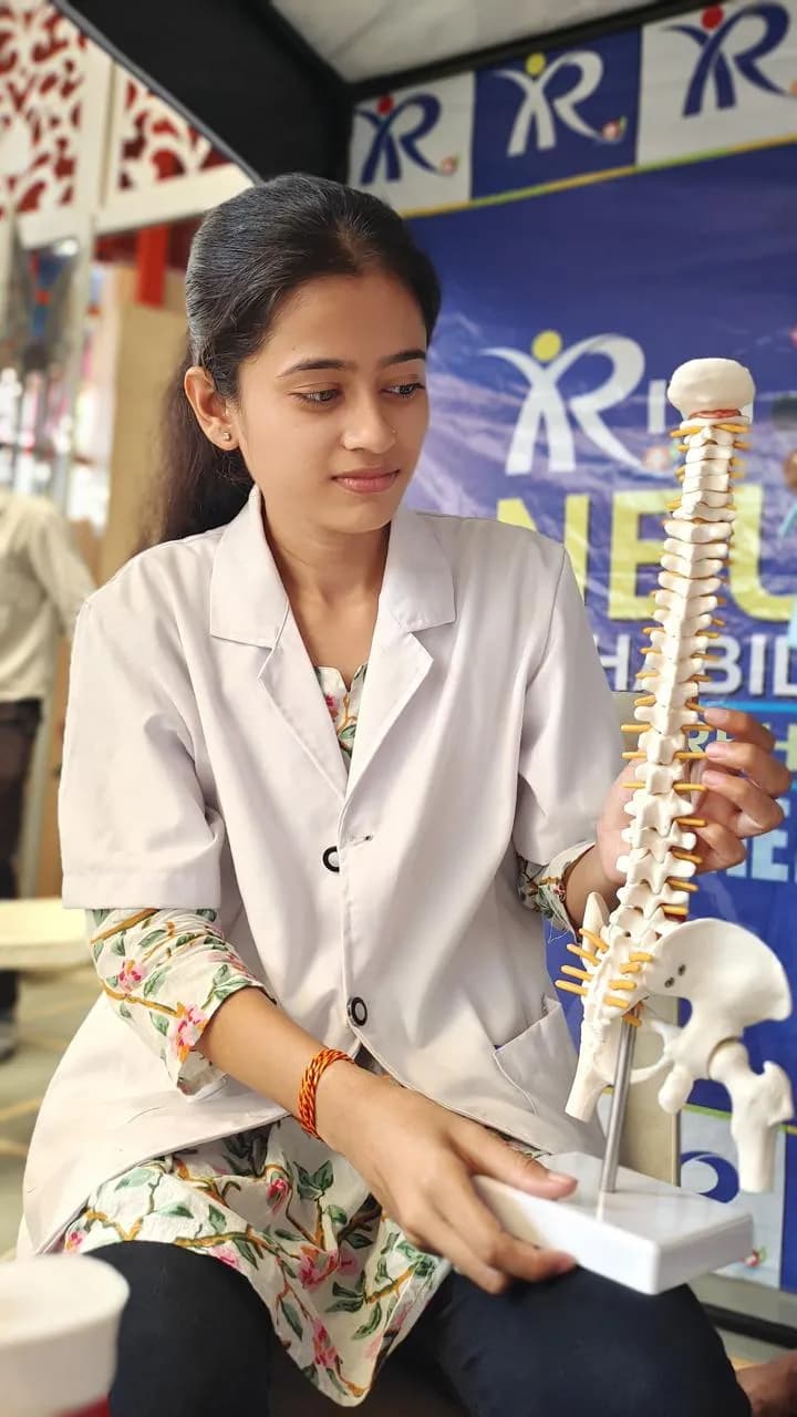 Therapist demonstrating on a spine model at a neuro-rehabilitation camp
